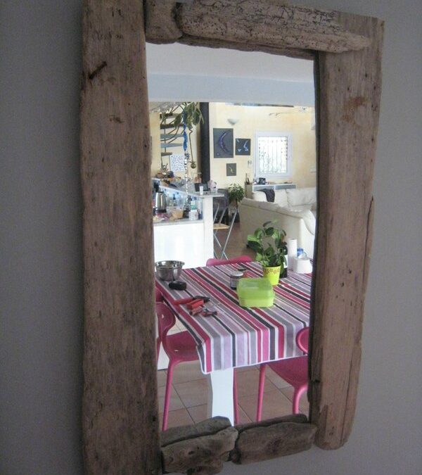 Un miroir encadré de bois flotté