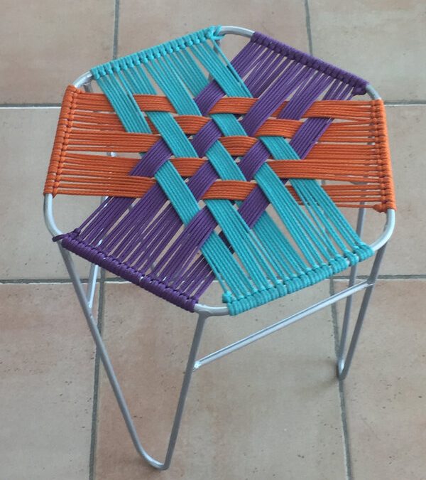 un tabouret en métal et corde tressée